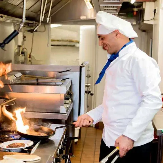 Stone Lodge Chef Created Meals, chef frying a dish.