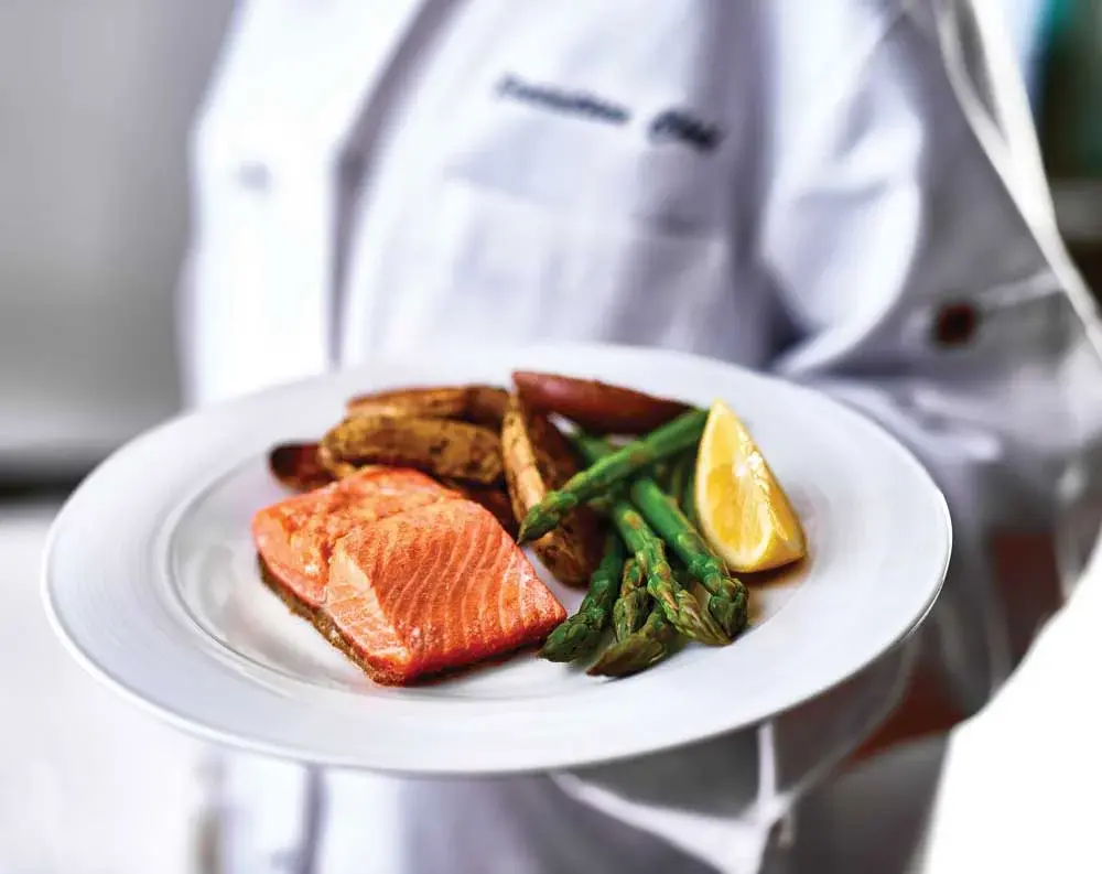 Stone Lodge Chef Created Meals, chef delivering a finished dish.