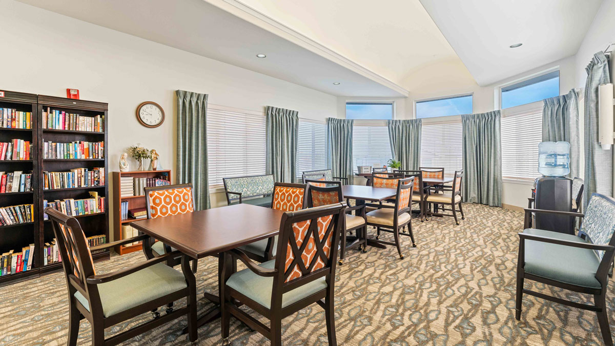 The library at Stone Lodge with shelves of books and comfortable seating